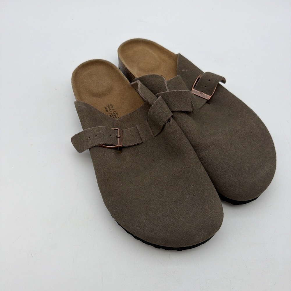 pair of taupe suede clogs featuring an adjustable strap Sz 10.5
